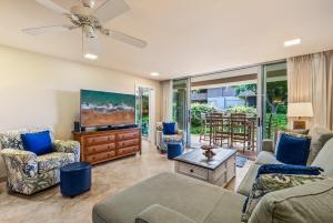a living room with a couch and a tv at Eldorado E102 · EL E102 Quiet Condo w Lanai AC Beach Cabana Gym in Kaanapali