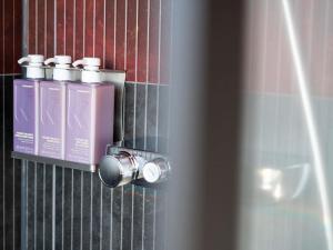 a close up of a door with three perfume bottles at Tribe Amsterdam City in Amsterdam +71 photos
