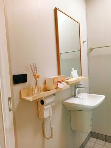 a bathroom with a sink and a mirror at ห่มฟ้าโพธิ์แค้มป์ปิ้ง  +2 photos