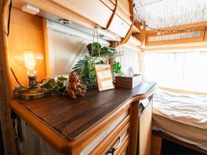 a kitchen with a wooden counter with plants and a bed at Kaamlanai Harbor - Vacation STAY 47900v in Nichinan +34 photos