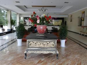 a living room with a table with a vase on it at Shangri-la Zhaxidele Hotel in Shangri-La
