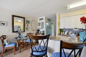 a kitchen with a counter and some chairs and a table at Lahaina Shores 428 · LS 428 Dream Vacation Studio by the Beach a in Lahaina