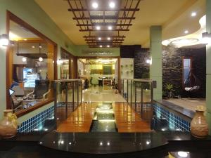 a lobby with a pool in the middle of a building at Chodkamol Place 57 in Nakhon Si Thammarat