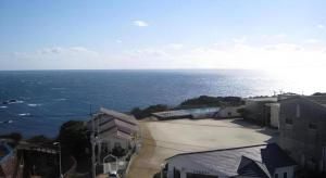 an aerial view of the ocean with buildings and houses at Hotel Kaijyokan in Isa
