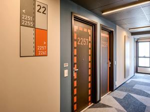 a hallway with doors and numbers on the wall at Ibis Budget Balneario Camboriu in Balneário Camboriú