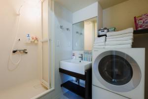 a bathroom with a sink and a washing machine at Nihonbashi Moonview in Wada +77 photos
