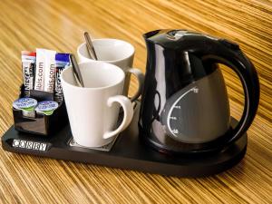 a black coffee pot and two cups on a tray at ibis budget London Heathrow Central in Hounslow