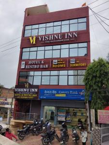 un edificio con motocicletas estacionadas frente a él en Hotel Vishnu Inn, en Rewa