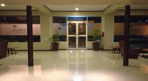 an empty lobby with potted plants in a building at Victoria Palms Hotel in The Domain