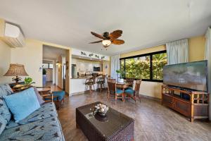 a living room with a couch and a flat screen tv at Papakea L101 · PK L101 Maui Ground-Floor Condo with Ocean Views in Honokowai