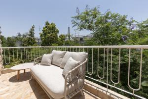 a wicker chair sitting on a balcony at The charm of Jerusalem in Jerusalem