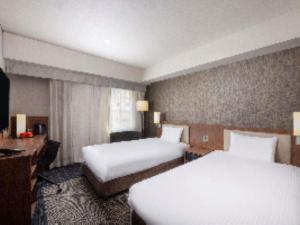 Postel nebo postele na pokoji v ubytování ibis Styles Tokyo Ginza