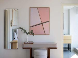 a dressing room with a desk and a mirror at Elkonin Tel Aviv - MGallery Hotel Collection in Tel Aviv +109 photos