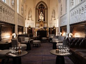 a restaurant with couches and tables and chairs at Domaine de la Reine Margot Paris-Issy - MGallery Collection in Issy-les-Moulineaux +163 photos