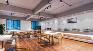 a restaurant with tables and chairs in a room at Xana Lite Ganzi Luding YanAn Road in Lutingkiao