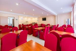 a conference room with red chairs and desks and tables at IU Hotel Changsha Railway Station Branch in Changsha