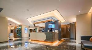 a lobby with a reception desk in a building at Yitel Xi'an Hi-tech Zone Wanda Plaza in Xi'an