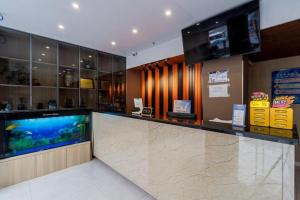 a bar with a fish aquarium in a store at Shanghai Jiejia hotel in Shanghai