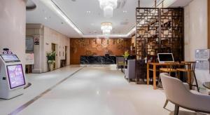 a lobby of a store with a desk and chairs at Yitel Shanghai Hongqiao Railway Station National Convention and Exhibition Center in Fangjiayao