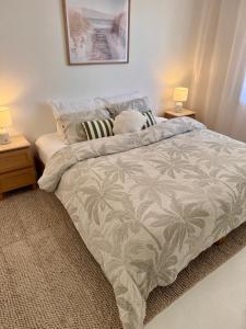 a bed in a bedroom with two night stands and two lamps at Walk to Beach - Coastal Beach House Retreat in Port Willunga