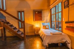 a bedroom with a bed and a staircase in a room at Cabañas en el Bosque a 5 minutos del mar - Estancia CH in Punta del Este +193 photos