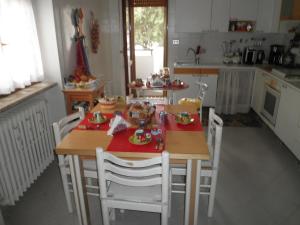 a kitchen with a table and chairs with food on it at Don Milani in Matera