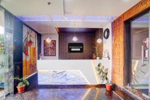 a lobby of a store with a sign on the wall at Super Townhouse Lighthouse Beach Formerly Neel Sagar in Puri