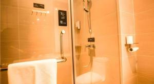 a bathroom with a shower with a glass door at City Comfort Inn Xianning Tongcheng Zhuangyuan Square in Tongcheng
