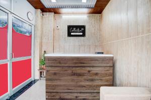a dental office with a red door and a sign on the wall at Collection O Palwal-Aligarh Crossway Formerly Hotel Kadamb in Palwal