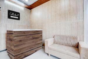 a waiting room with a chair and a sign on the wall at Collection O Palwal-Aligarh Crossway Formerly Hotel Kadamb in Palwal