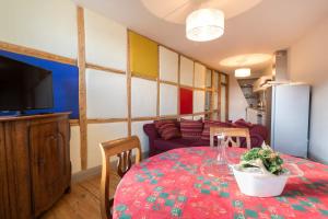 a living room with a table and a couch at Les Appartements Saint Nicolas in Colmar