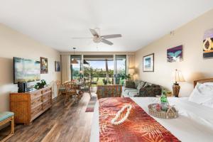 a bedroom with a bed and a living room at Eldorado A108 in Kaanapali