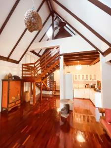 a large living room with wooden floors and a staircase at Baan Zen - 6 PAX Waterfront Retreat - 200 mt from the beach in Ban Map Khangkhao