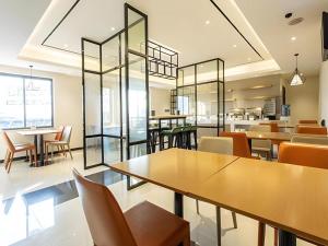 un comedor con mesas y sillas en City Comfort Inn Nanning Wuming, en Wuming