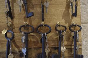 a bunch of keys hanging on a wall at Hôtel de Garlande in Avignon