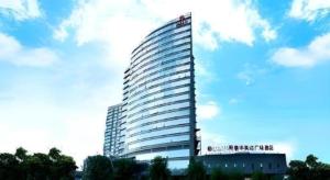 a tall building with a sign on the side of it at Ramada Plaza by Wyndham Shaowu in Liaojiapai +13 photos