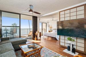 a living room with a bed and a living room with a view at Lauloa 303 in Maalaea +42 photos