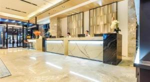 a lobby with a reception desk in a building at Echarm Hotel Guiyang Qianling Mountain in Guiyang