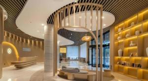 a lobby with a couch and a staircase in a building at Deep Sleep Hotel Xuzhou High-Speed Railway Station East Square Oubeisha in Xuzhou +162 photos