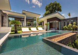 a swimming pool in front of a house at Villa Raku in Koh Samui 