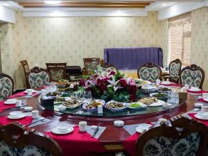 a table with plates of food on it at Green Tree Inn Tibet Lhasa Zhaji Temple in Lhasa