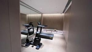 a gym with two exercise bikes and a mirror at JI Hotel Shanghai International Tourism Resort Chongxi Road in Nanhui +23 photos