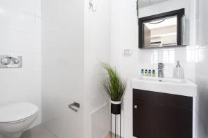 a bathroom with a sink and a toilet and a mirror at Yaffo apartament in Jerusalem