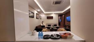 a living room with a table with food on it at Goldcrest Luxury Apartments in Lahore