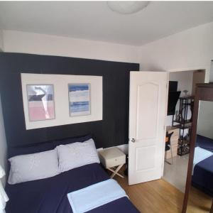 a bedroom with a bed and a white door at Brookridge Suites in Cebu City