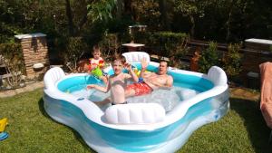 a group of people in a pool in a backyard at Kalogirou Stone House in Limnionas