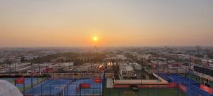 a view of a city at sunset from a building at Goldcrest Luxury Apartments in Lahore