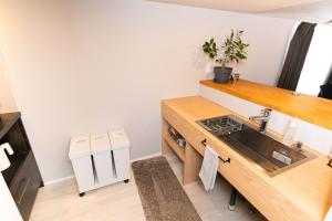 a kitchen with a sink and a counter at Rino-Haku 02 in Anan