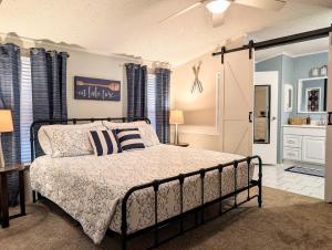 a bedroom with a bed with a black frame at Rough River Lake Cabin Fishing in Fentress McMahan