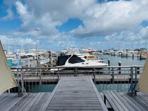 a dock with a boat in a marina with boats at Sunset Marina Escape Freo-amazing Views & Central in Fremantle